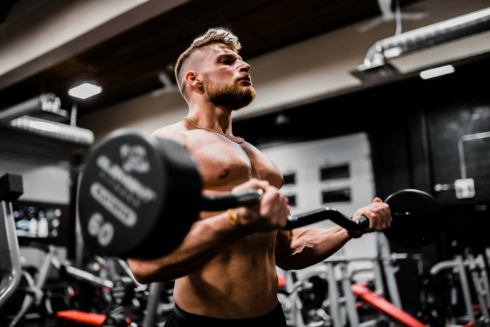 Conditioning session with sleds and kettlebells at the back of the gym